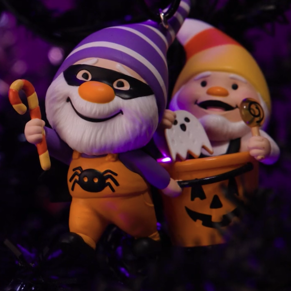 A Halloween Keepsake Ornament featuring series characters Gnaughty and Gnice, two mischievious gnomes, all dressed up for trick-or-treating.